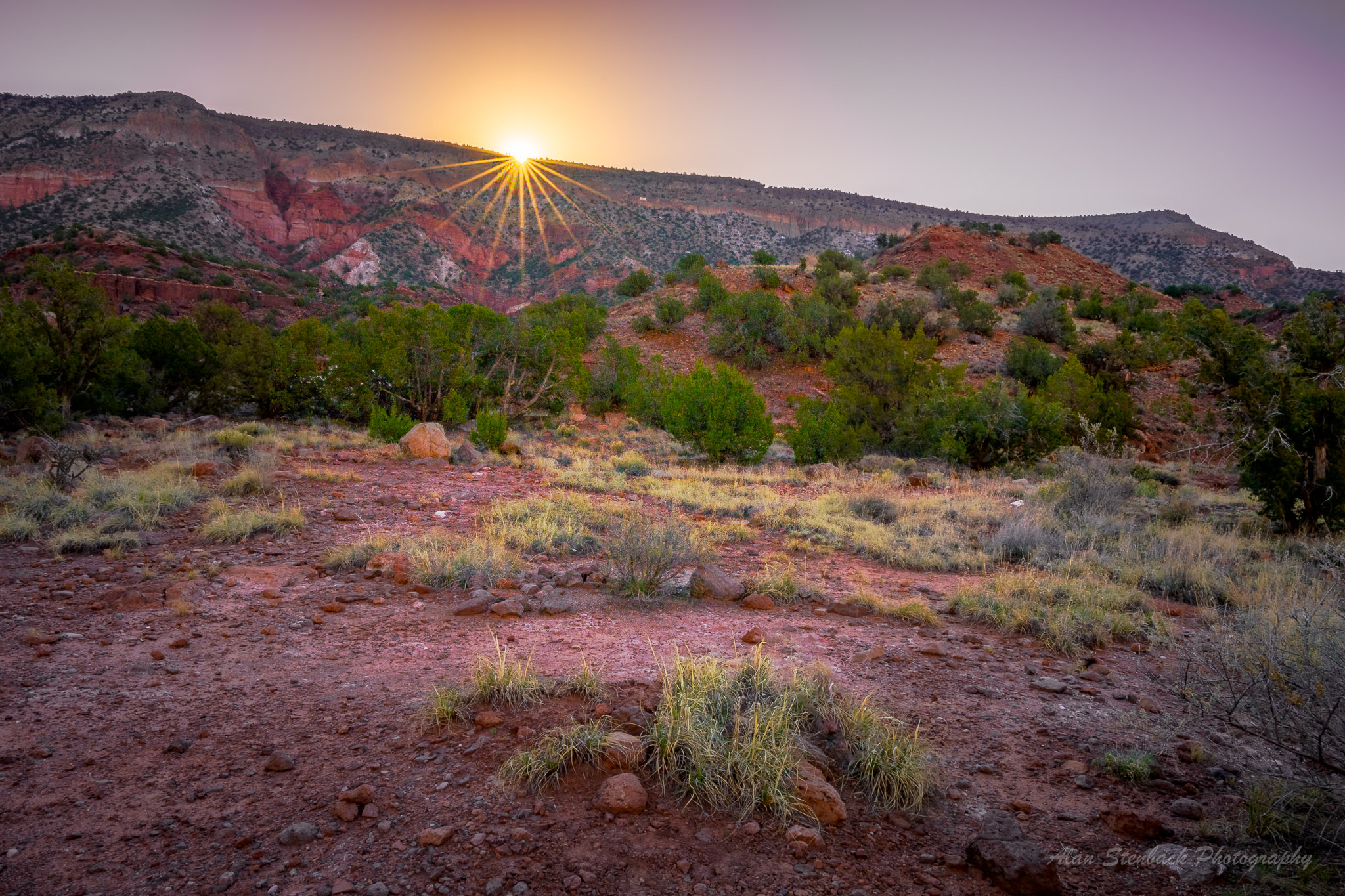 Sunrise over Palo Duro Canyon with vibrant red rock formations and lush greenery, creating a stunning natural landscape in Texas.